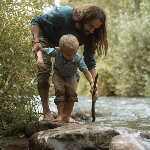 Sean Despain from W.I.P Services with his son by a creek in Utah
